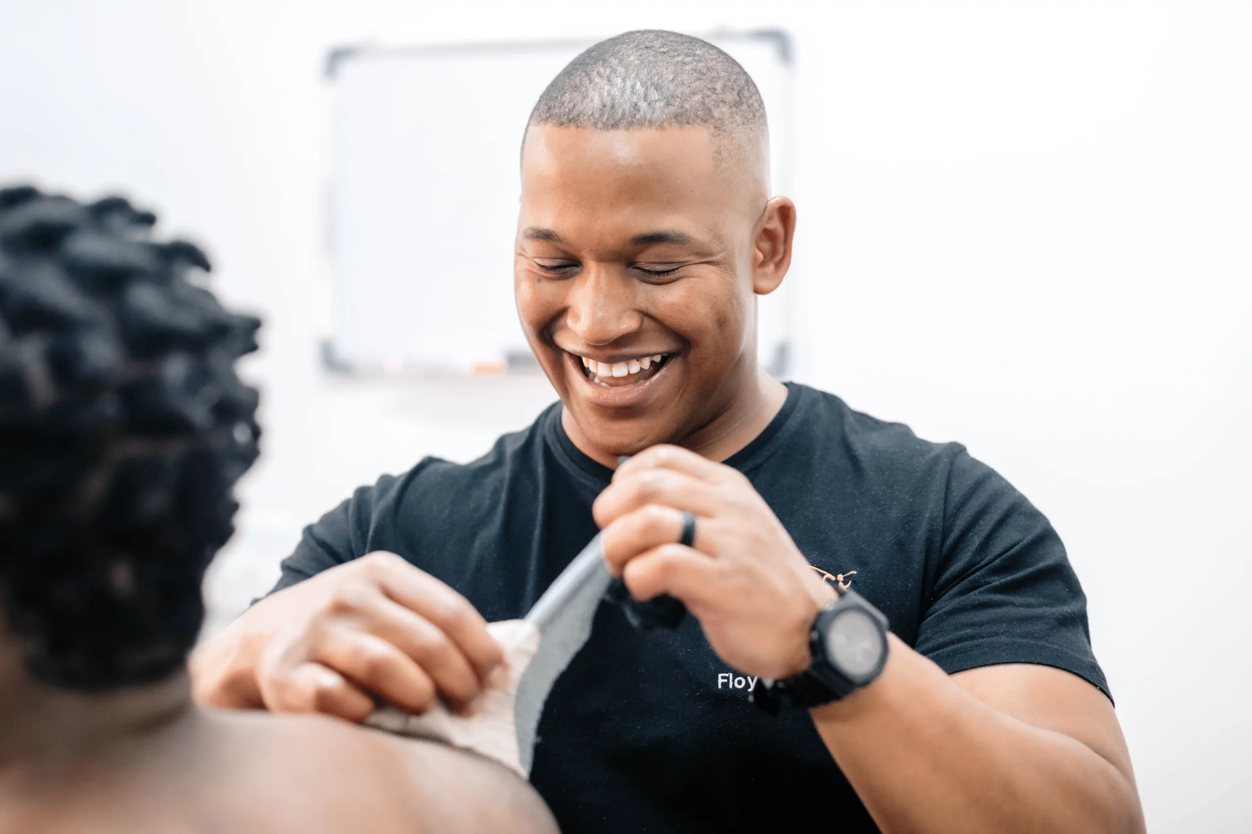 Physiotherapist taping shoulder for joint stability and support