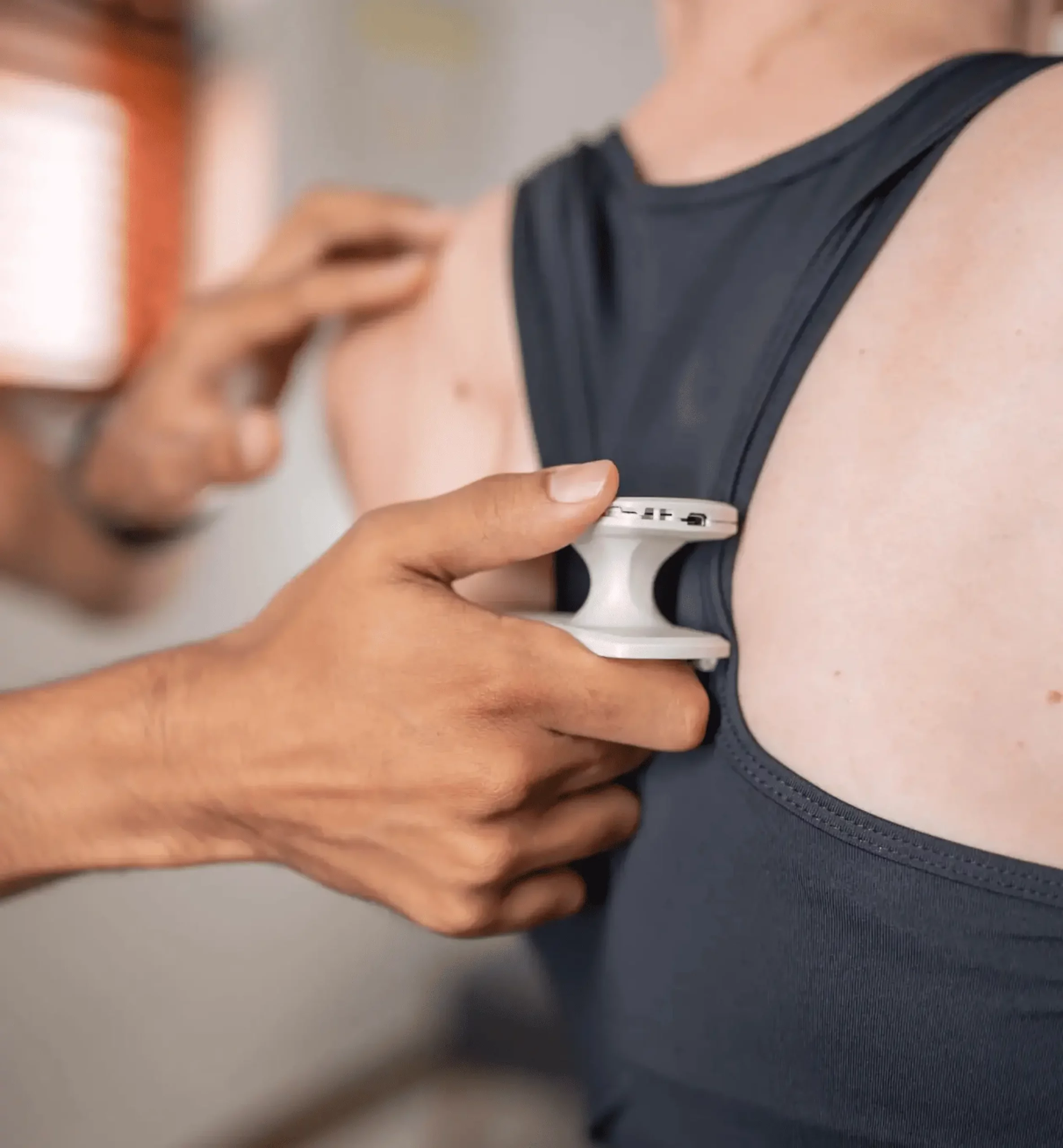 Close-up of physiotherapy device applied to patient’s back for spinal pain relief and stimulation