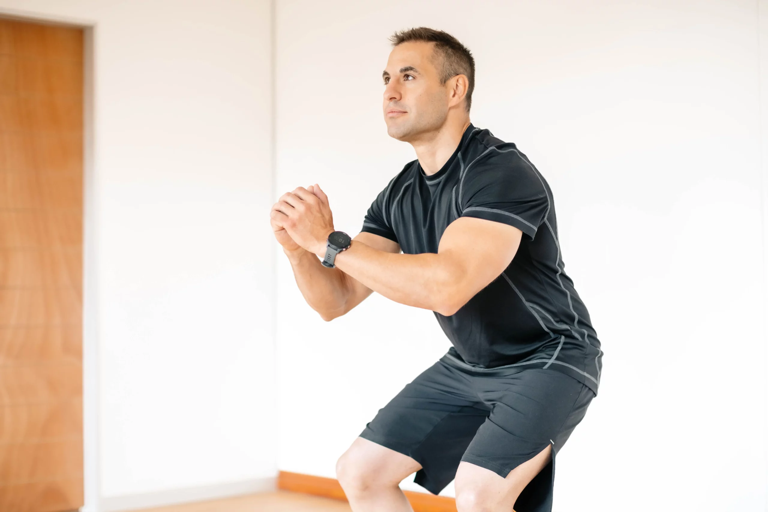 Who We Are 15 Male patient performing deep squat mobility exercise as part of executive rehabilitation programme